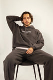 Oracle Hoodie in Midnight Dust — Male Model Sitting